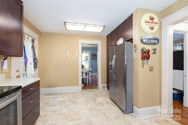 206 Mitchell Ave, Salisbury, NC 28144 - kitchen with appliances with stainless steel finishes, dark brown cabinets, and light countertops