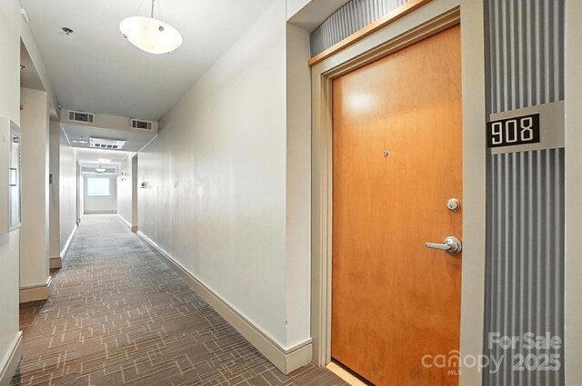 505 E 6th St Unit 908, Charlotte, NC 28202 - hallway with brick patterned flooring and baseboards
