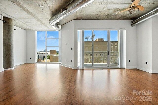 505 E 6th St Unit 908, Charlotte, NC 28202 - unfurnished room featuring wood finished floors, plenty of natural light, and a ceiling fan