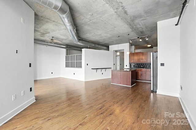 505 E 6th St Unit 908, Charlotte, NC 28202 - unfurnished living room with dark wood-style floors and ceiling fan