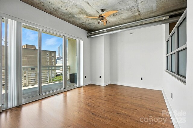 505 E 6th St Unit 908, Charlotte, NC 28202 - empty room with wood finished floors and a ceiling fan