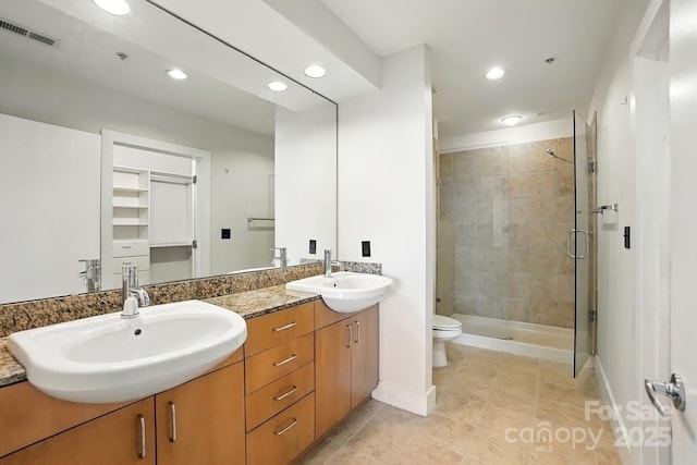 505 E 6th St Unit 908, Charlotte, NC 28202 - bathroom featuring double vanity, a shower stall, recessed lighting, and tile patterned flooring