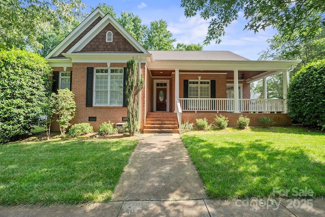 320 Magnolia St, Davidson, NC 28036 - view of front of property featuring brick siding, covered porch, a front lawn, and crawl space