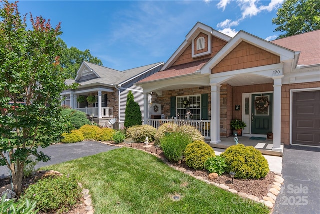 190 Shaws Creek Farm Rd, Hendersonville, NC 28739 - view of front facade featuring covered porch, stone siding, and a front yard