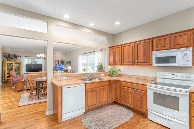 190 Shaws Creek Farm Rd, Hendersonville, NC 28739 - kitchen with white appliances, ornamental molding, light countertops, light wood finished floors, and brown cabinets