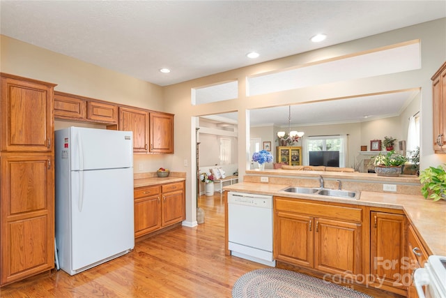 190 Shaws Creek Farm Rd, Hendersonville, NC 28739 - kitchen with white appliances, light countertops, brown cabinetry, light wood-style floors, and a chandelier