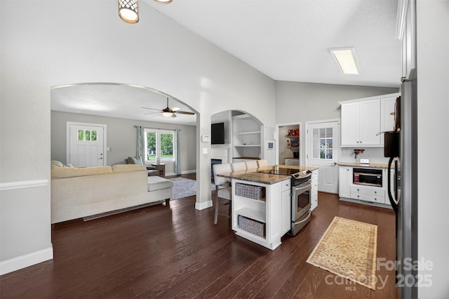 106 Abbey Cir, Salisbury, NC 28147 - kitchen featuring arched walkways, stainless steel electric range, white cabinets, open floor plan, and a center island