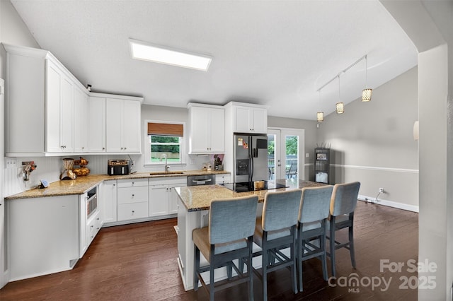 106 Abbey Cir, Salisbury, NC 28147 - kitchen featuring appliances with stainless steel finishes, a kitchen breakfast bar, and white cabinets
