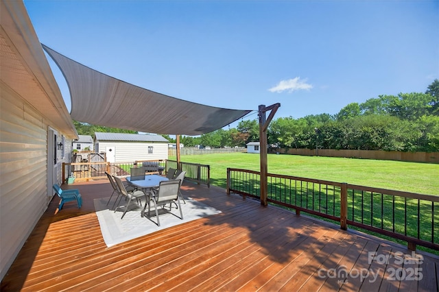 106 Abbey Cir, Salisbury, NC 28147 - wooden deck featuring outdoor dining space, a storage unit, and a fenced backyard