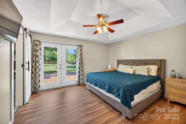 106 Abbey Cir, Salisbury, NC 28147 - bedroom with a tray ceiling, a textured ceiling, wood finished floors, access to exterior, and french doors