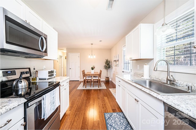 50 Serenity Ln, Hickory, NC 28601 - kitchen with stainless steel appliances, light wood-type flooring, light countertops, and white cabinets