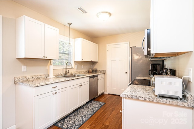 50 Serenity Ln, Hickory, NC 28601 - kitchen with appliances with stainless steel finishes, dark wood finished floors, white cabinetry, and pendant lighting