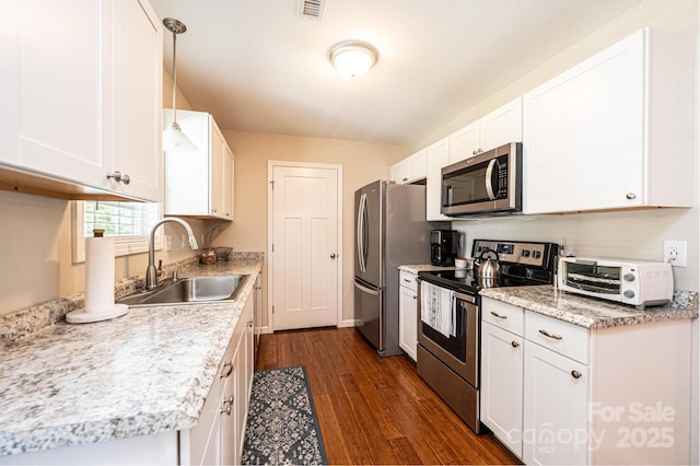 50 Serenity Ln, Hickory, NC 28601 - kitchen featuring appliances with stainless steel finishes, dark wood finished floors, white cabinets, and hanging light fixtures