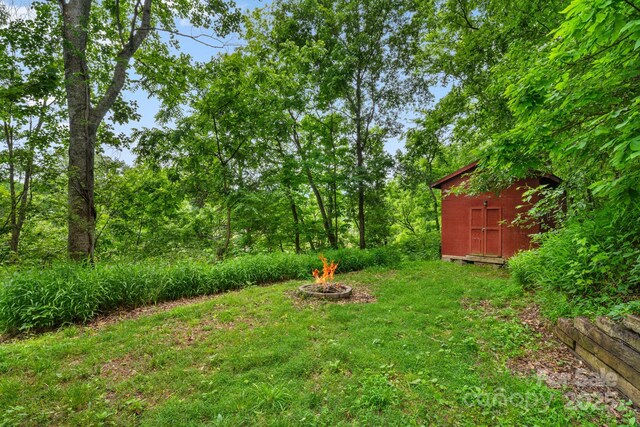 6 Kims Ct, Clyde, NC 28721 - view of yard with a fire pit and a storage unit
