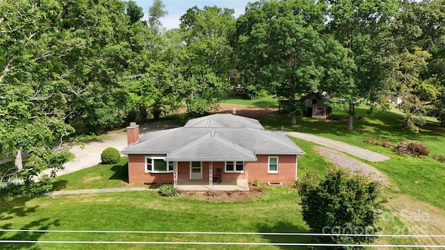 455 Cane Creek Rd, Fletcher, NC 28732 - view of front of house featuring covered porch, a front lawn, brick siding, a chimney, and view of wooded area