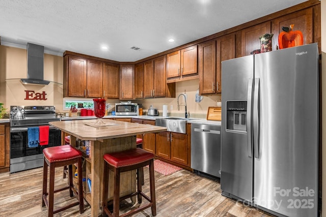 200 Vista Pointe Dr, Stony Point, NC 28678 - kitchen with stainless steel appliances, wall chimney range hood, butcher block counters, light wood finished floors, and recessed lighting