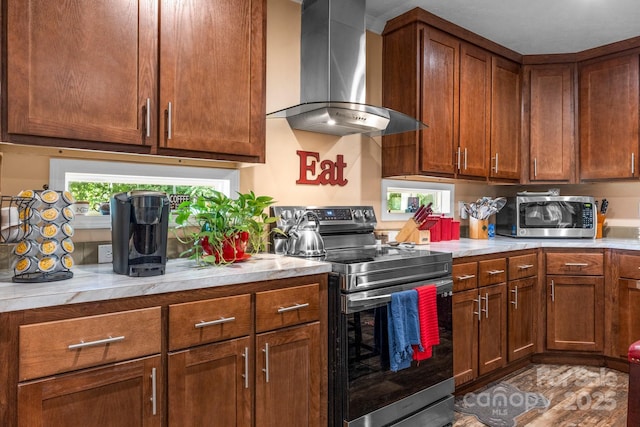 200 Vista Pointe Dr, Stony Point, NC 28678 - kitchen with wall chimney exhaust hood, stainless steel appliances, light countertops, and brown cabinetry