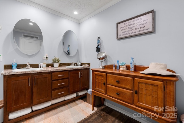 200 Vista Pointe Dr, Stony Point, NC 28678 - bathroom with crown molding, double vanity, wood finished floors, a textured ceiling, and recessed lighting