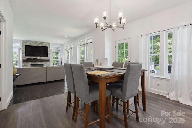 9954 Mitchell Glen Dr, Charlotte, NC 28277 - dining room featuring a chandelier, dark wood-style floors, and a fireplace