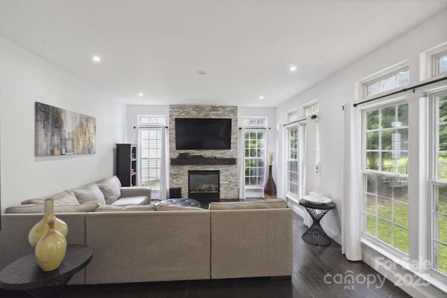 9954 Mitchell Glen Dr, Charlotte, NC 28277 - living area with a stone fireplace, healthy amount of natural light, dark wood-style flooring, and recessed lighting