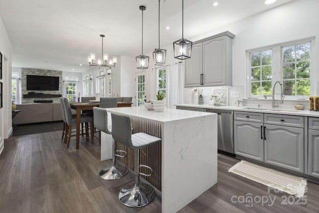 9954 Mitchell Glen Dr, Charlotte, NC 28277 - kitchen with stainless steel dishwasher, gray cabinets, dark wood-type flooring, a center island, and recessed lighting