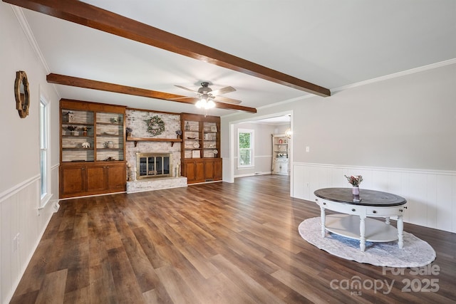 10206 Washam Potts Rd, Cornelius, NC 28031 - unfurnished living room featuring beam ceiling, wood finished floors, wainscoting, a ceiling fan, and a brick fireplace