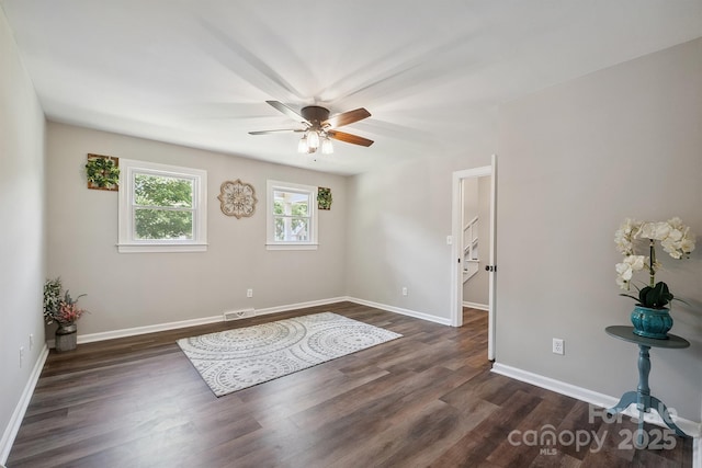 10206 Washam Potts Rd, Cornelius, NC 28031 - empty room with dark wood-style flooring and ceiling fan