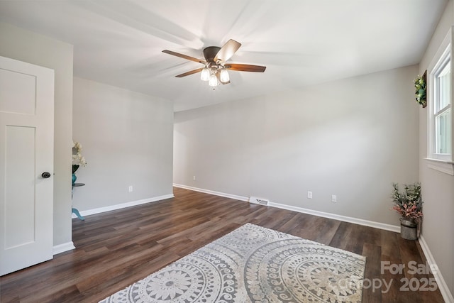 10206 Washam Potts Rd, Cornelius, NC 28031 - empty room with a ceiling fan and dark wood-style flooring