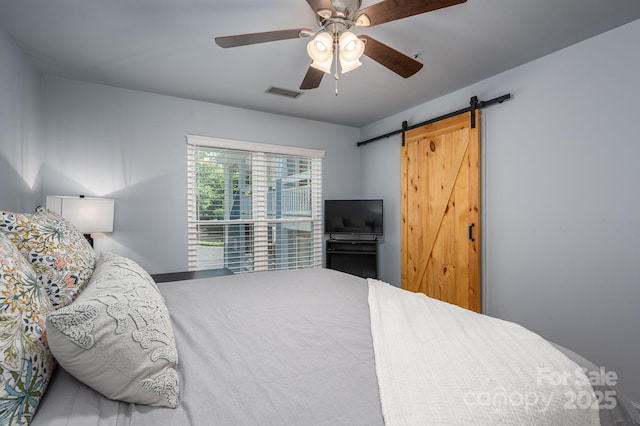 1018 SW Dr SW Unit 18, Davidson, NC 28036 - bedroom featuring a barn door and ceiling fan