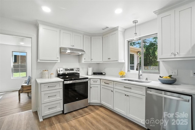 2705 Lowell Bethesda Rd, Gastonia, NC 28056 - kitchen featuring appliances with stainless steel finishes, under cabinet range hood, light countertops, light wood-type flooring, and recessed lighting