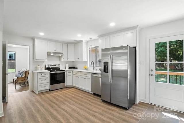 2705 Lowell Bethesda Rd, Gastonia, NC 28056 - kitchen featuring appliances with stainless steel finishes, under cabinet range hood, light countertops, light wood finished floors, and recessed lighting