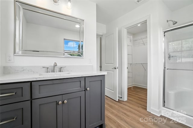 2705 Lowell Bethesda Rd, Gastonia, NC 28056 - full bathroom with a shower stall, a spacious closet, vanity, and wood finished floors