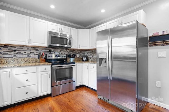 3651 16th St NE, Hickory, NC 28601 - kitchen with stainless steel appliances, white cabinets, dark wood-type flooring, ornamental molding, and backsplash