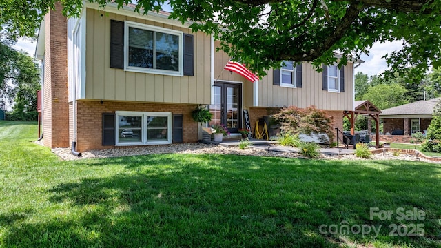 3651 16th St NE, Hickory, NC 28601 - raised ranch with brick siding, a front lawn, french doors, and a chimney
