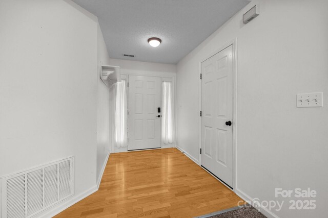 385 Glensprings Dr Unit 269, Fletcher, NC 28732 - doorway to outside with light wood-style flooring and a textured ceiling