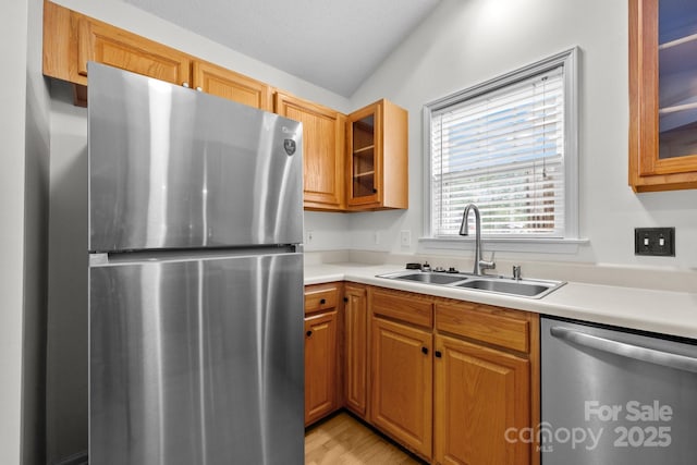 385 Glensprings Dr Unit 269, Fletcher, NC 28732 - kitchen featuring appliances with stainless steel finishes, light countertops, glass insert cabinets, and brown cabinetry