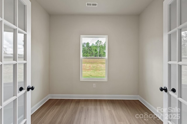 7106 Jerimoth Dr, Charlotte, NC 28215 - empty room with french doors and light wood-type flooring