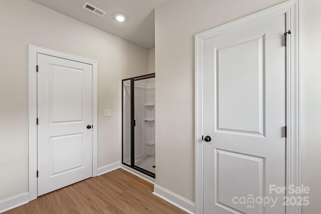 7106 Jerimoth Dr, Charlotte, NC 28215 - bathroom featuring wood finished floors, a stall shower, and recessed lighting