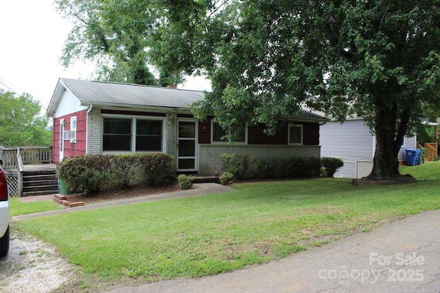 50 Huffman Rd, Asheville, NC 28806 - ranch-style home with brick siding, a front yard, and a wooden deck