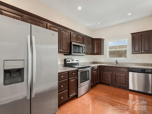 78 W Chapel Rd, Asheville, NC 28803 - kitchen with stainless steel appliances, dark brown cabinets, light wood-style flooring, and recessed lighting