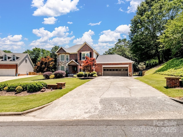 165 Cottontail Ln SE, Concord, NC 28025 - view of front of home featuring concrete driveway, an attached garage, a front lawn, and stone siding