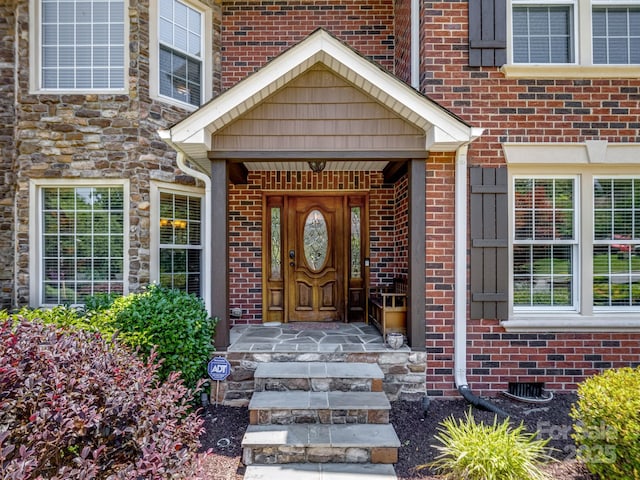 165 Cottontail Ln SE, Concord, NC 28025 - view of exterior entry featuring brick siding and crawl space