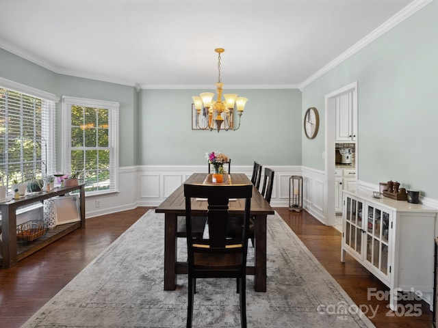 165 Cottontail Ln SE, Concord, NC 28025 - dining room with a chandelier, ornamental molding, a wainscoted wall, and dark wood-type flooring
