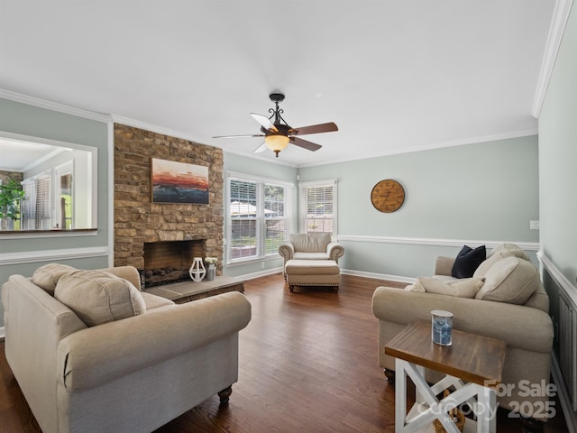 165 Cottontail Ln SE, Concord, NC 28025 - living area featuring a stone fireplace, ornamental molding, ceiling fan, and dark wood-type flooring