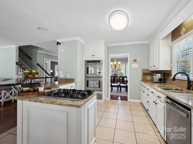 165 Cottontail Ln SE, Concord, NC 28025 - kitchen with stainless steel appliances, crown molding, light tile patterned flooring, white cabinets, and backsplash