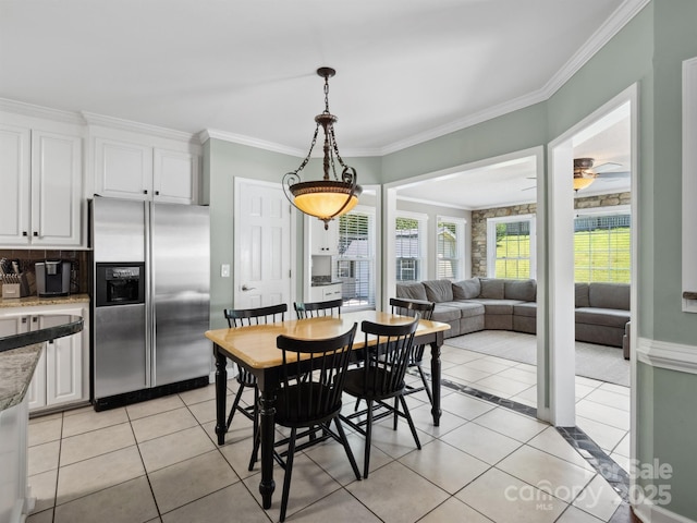 165 Cottontail Ln SE, Concord, NC 28025 - dining area with light tile patterned flooring, crown molding, and ceiling fan