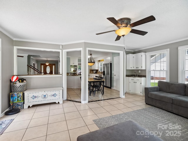 165 Cottontail Ln SE, Concord, NC 28025 - living area featuring ceiling fan, light tile patterned flooring, and crown molding