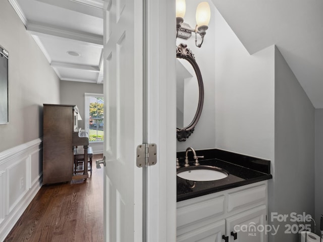165 Cottontail Ln SE, Concord, NC 28025 - bathroom with wood finished floors, vanity, wainscoting, crown molding, and a decorative wall