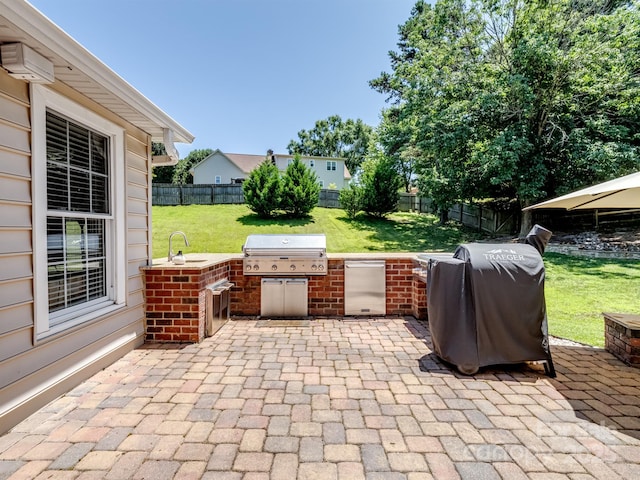 165 Cottontail Ln SE, Concord, NC 28025 - fenced backyard featuring exterior kitchen and a patio area