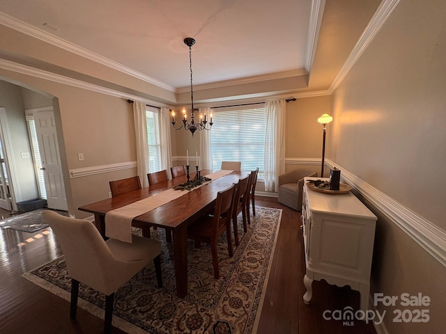 1808 Mill Chase Ln, Waxhaw, NC 28173 - dining area featuring dark wood-style floors, a chandelier, arched walkways, ornamental molding, and a raised ceiling